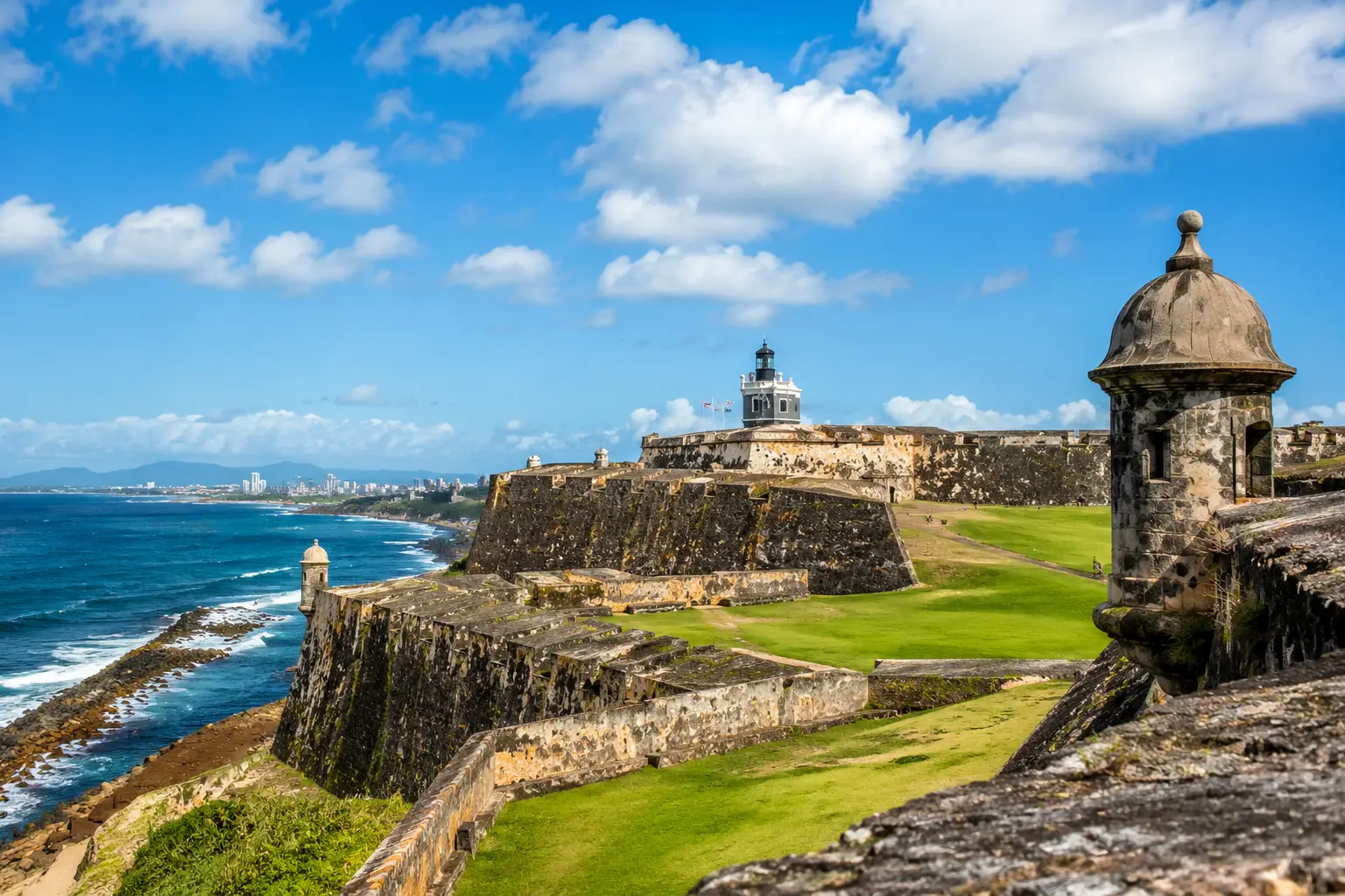 A stone sentry tower and the lawns of Castillo San Felipe del Morro overlook the Atlantic in Old San Juan.