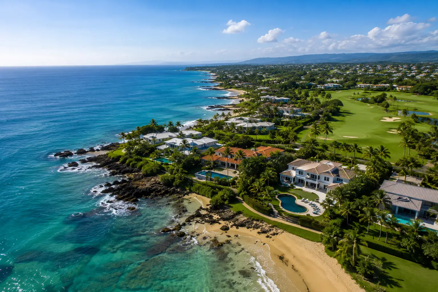 Aerial view of Dorado del Mar in Dorado, Puerto Rico, featuring luxury homes, palm-lined streets, pristine beaches, championship golf courses, and the Caribbean coastline.