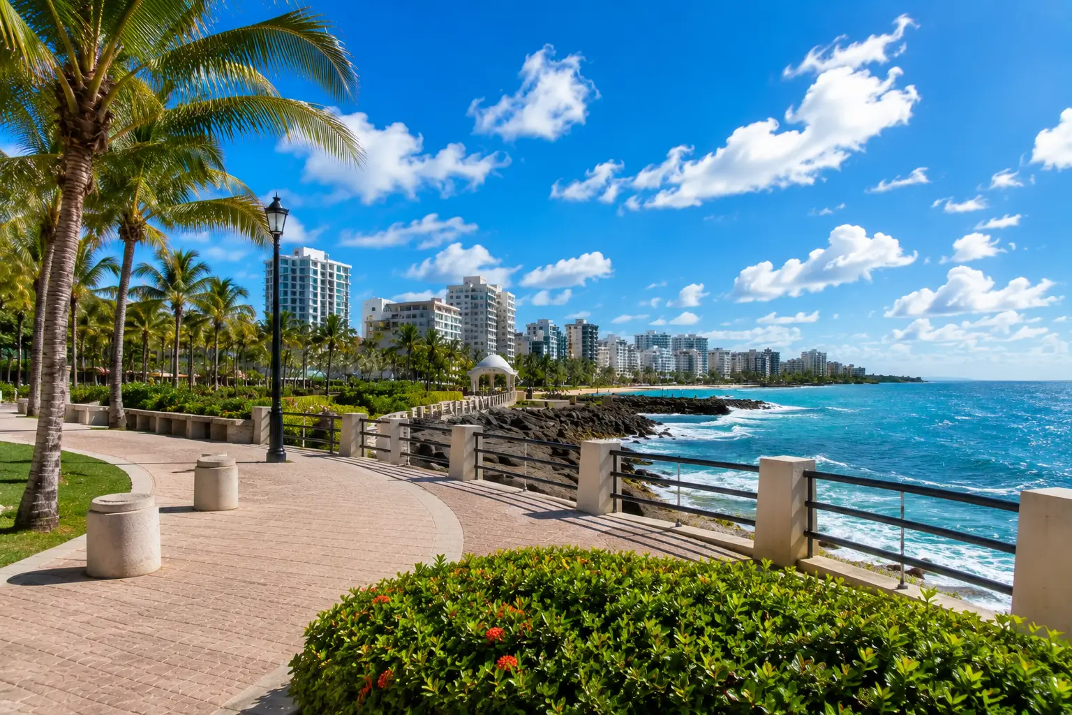 Palm trees, benches and stone paths overlook the ocean at Ventana al Mar Park in Condado, San Juan.