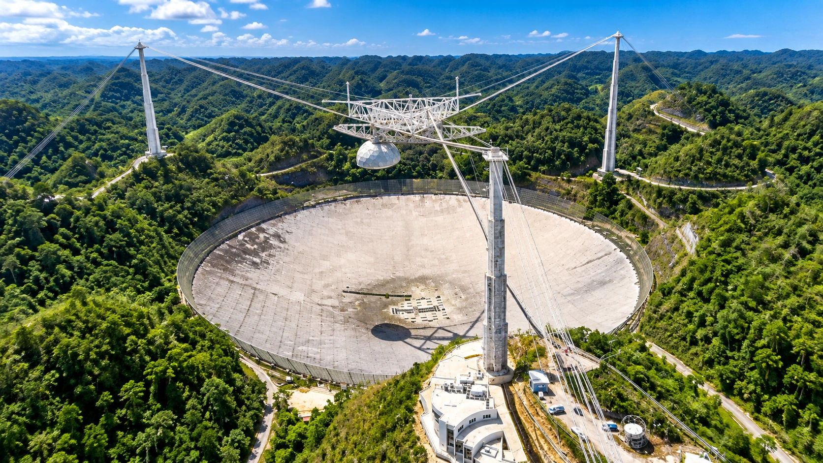Arecibo Observatory site surrounded by green karst landscape in Arecibo, Puerto Rico.