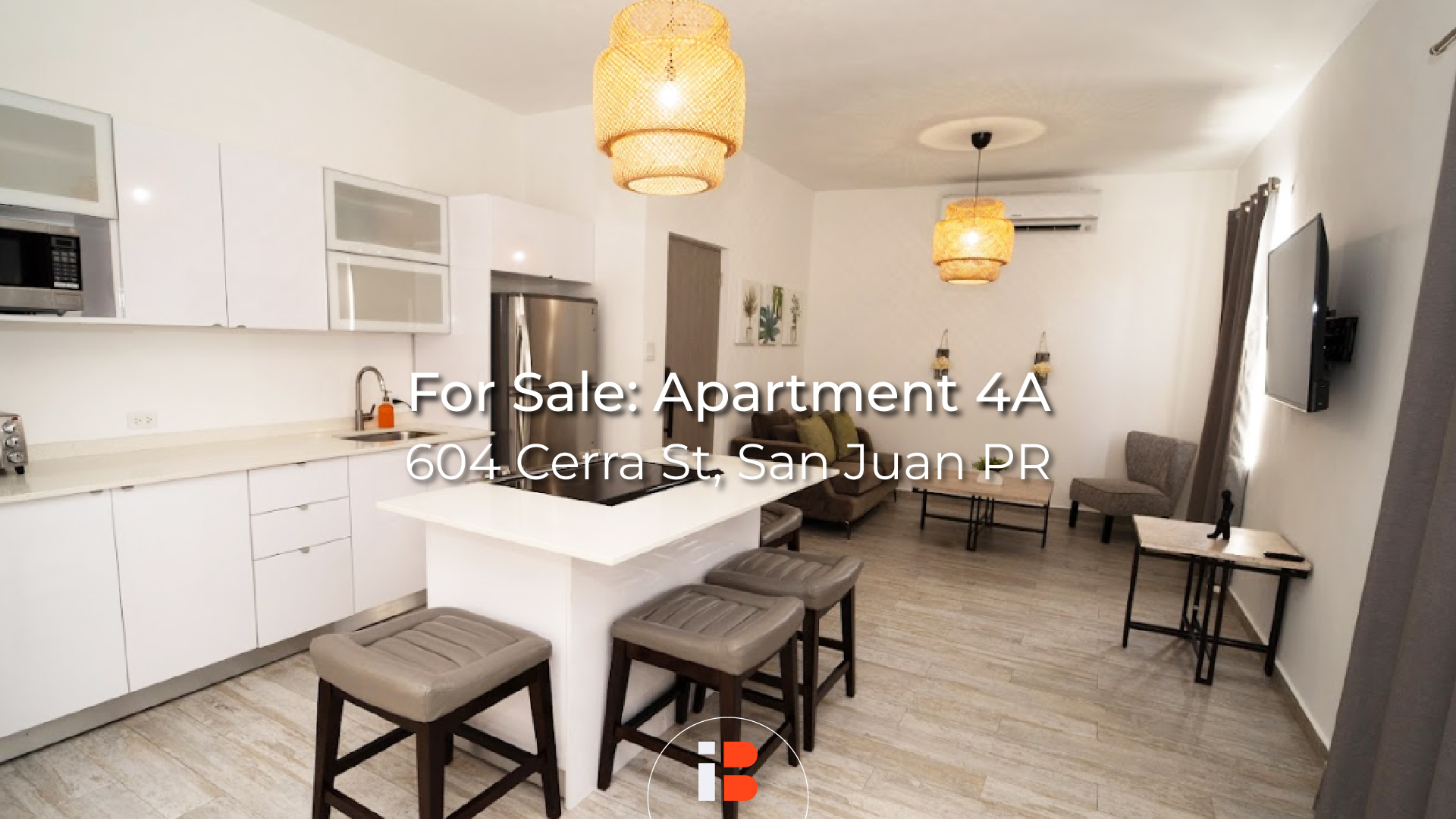 Apartment 4A Interior Apartment kitchen with white cabinets, island seating and listing text.
