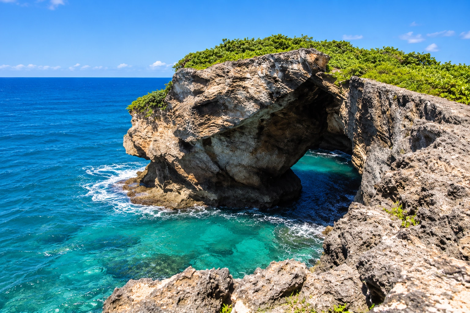 Coastal rock formations and cave landscape at Cueva del Indio in Arecibo, Puerto Rico, overlooking the Atlantic Ocean.