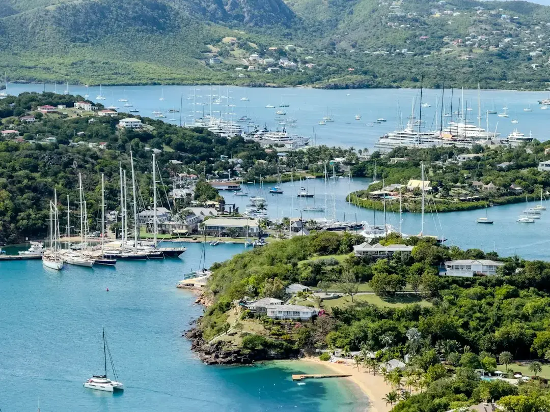 Yachts, marinas, waterfront buildings, and green hills in English Harbour, Antigua