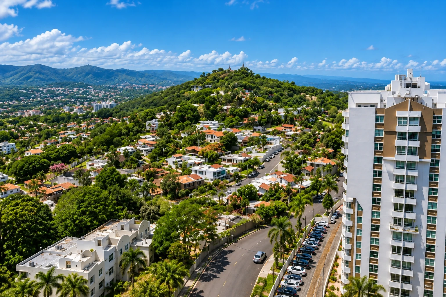 Homes and apartment buildings amid green hills in Frailes, Guaynabo.