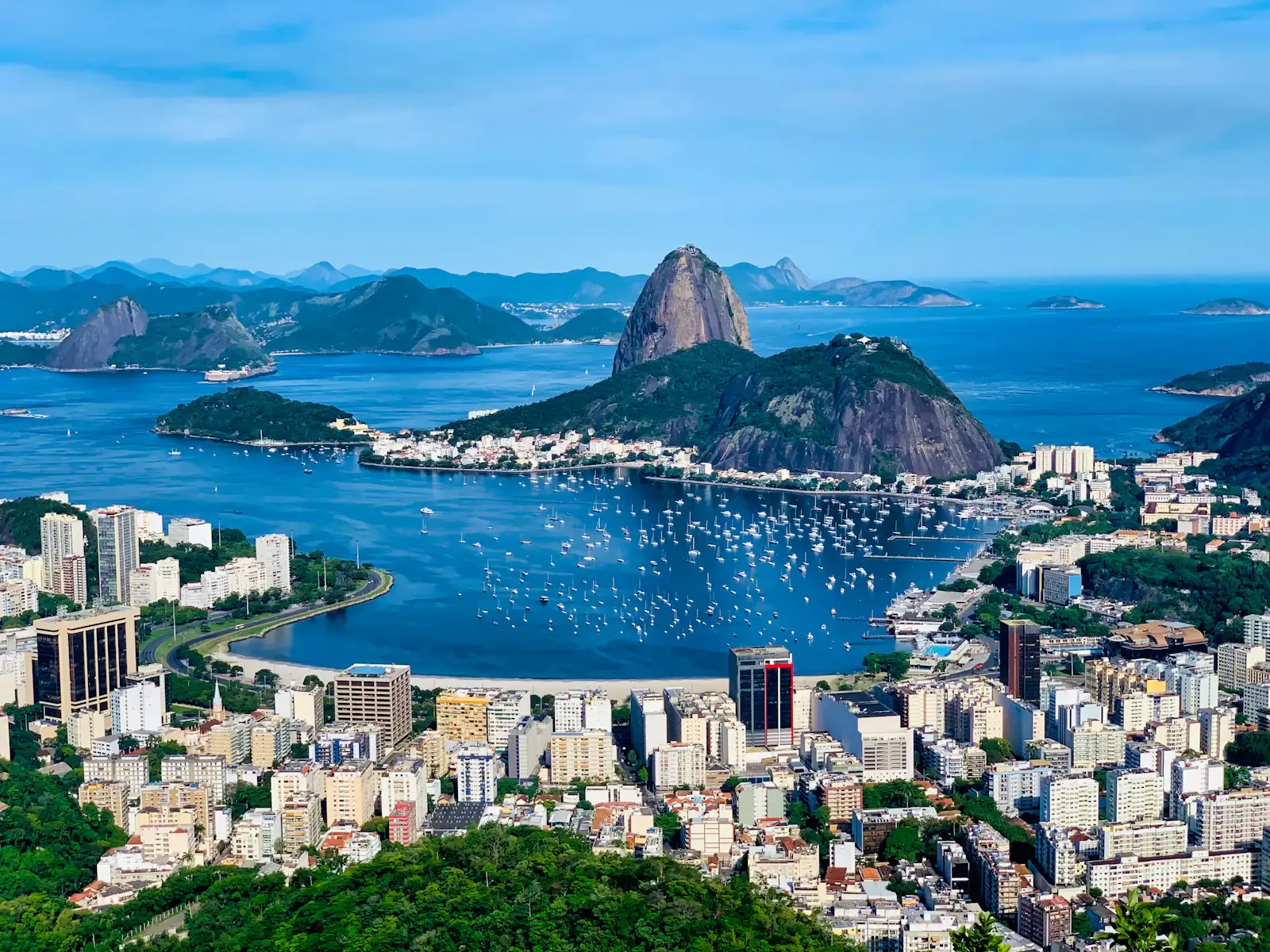 Apartment buildings around Botafogo Bay, sailboats on the water and Sugarloaf Mountain in Rio de Janeiro, Brazil.