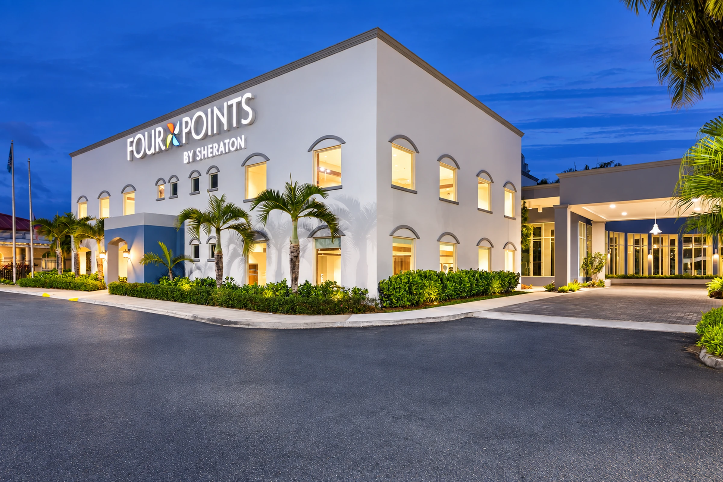 Four Points Caguas Real Hotel Four Points Caguas Real hotel exterior with palms and an entrance driveway.