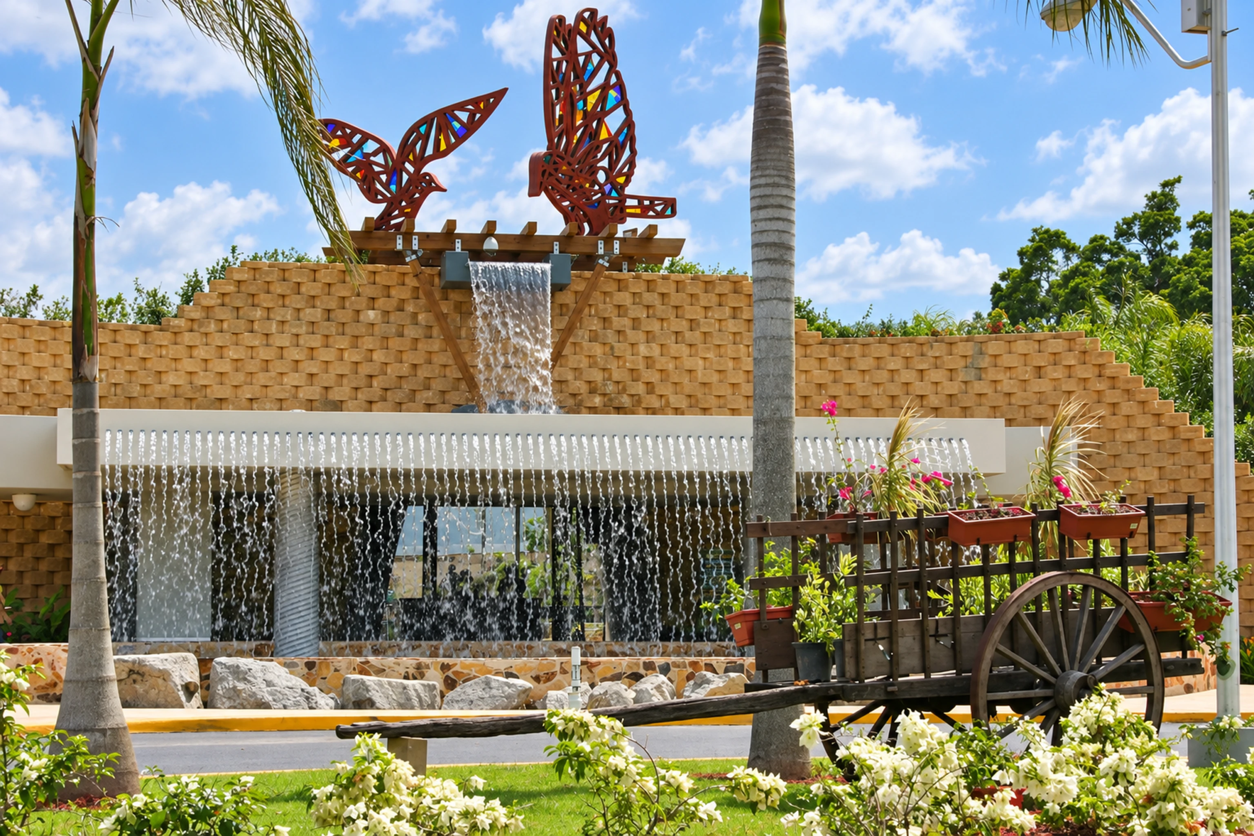 Butterfly sculpture fountain surrounded by palms at Caguas Botanical Garden.