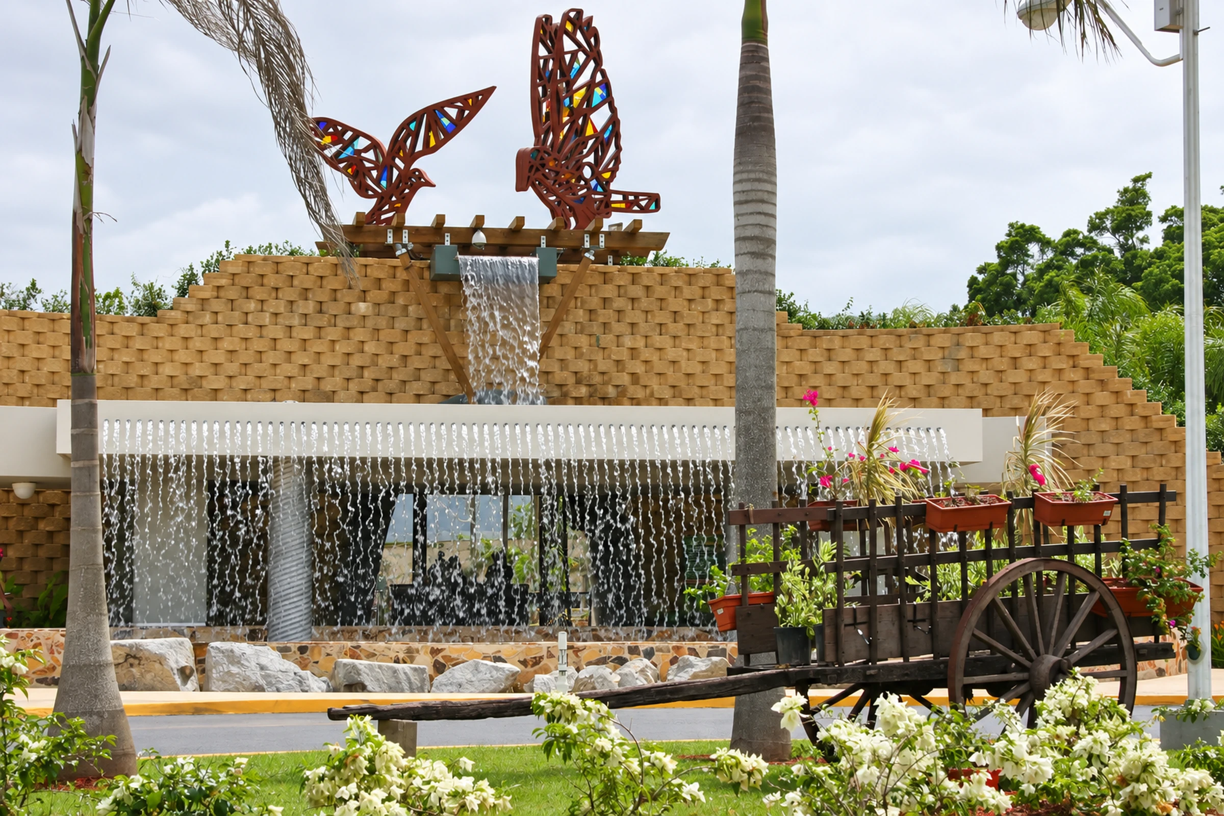 Waterfall fountain with butterfly sculptures at Caguas Botanical Garden.