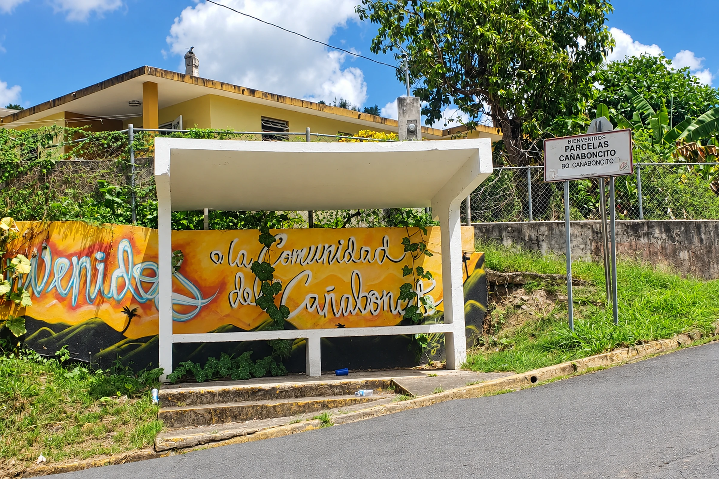 Bus shelter, colorful mural and neighborhood sign in Cañaboncito, Caguas.
