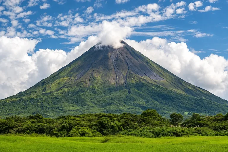 Arenal Volcano rising above lush tropical landscape in Costa Rica