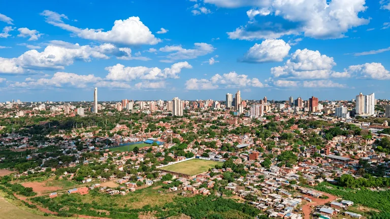 Asunción’s skyline, neighborhoods and green spaces beneath a bright blue sky in Paraguay