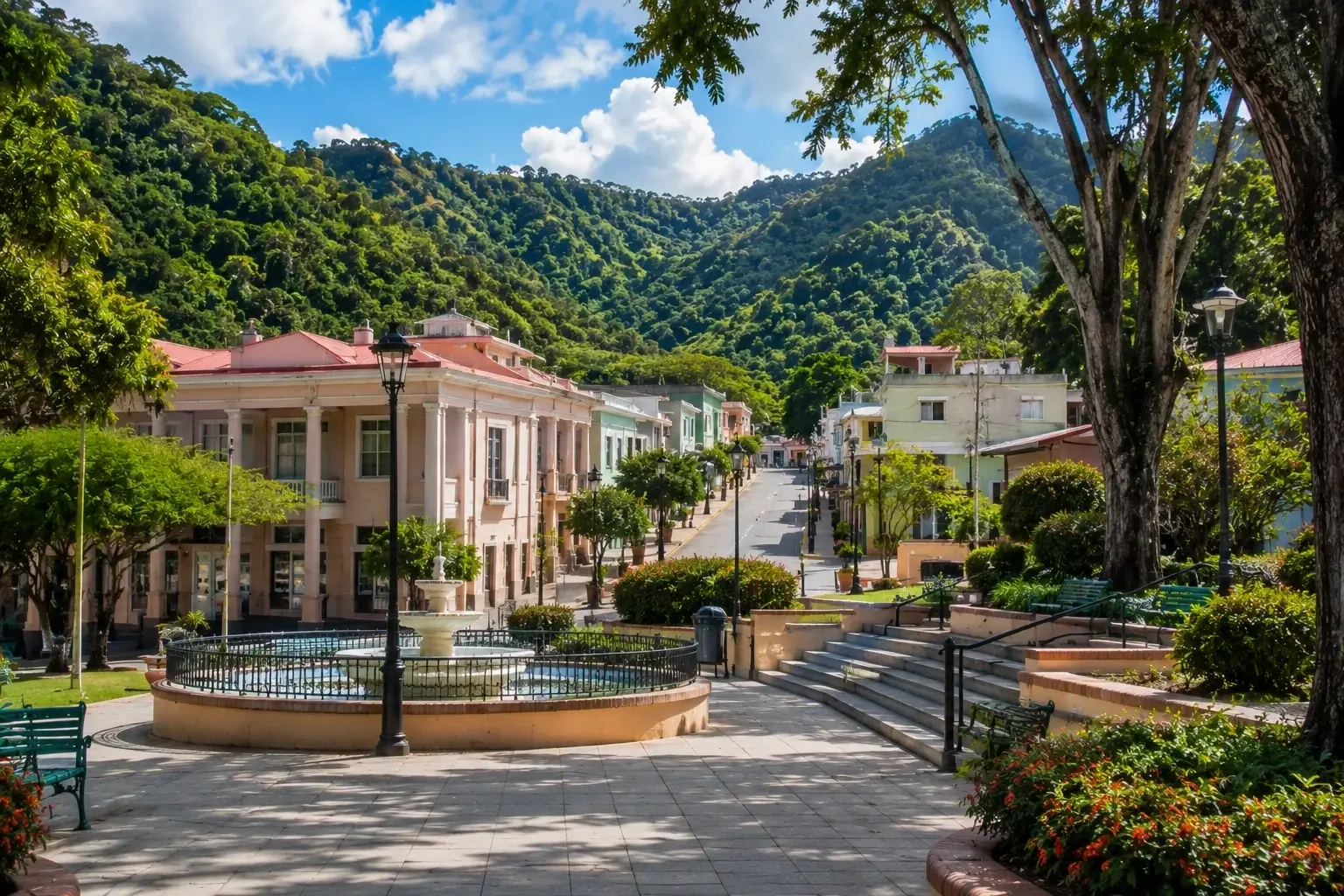 Traditional town plaza and colorful architecture surrounded by lush mountains in Adjuntas Pueblo, Puerto Rico.