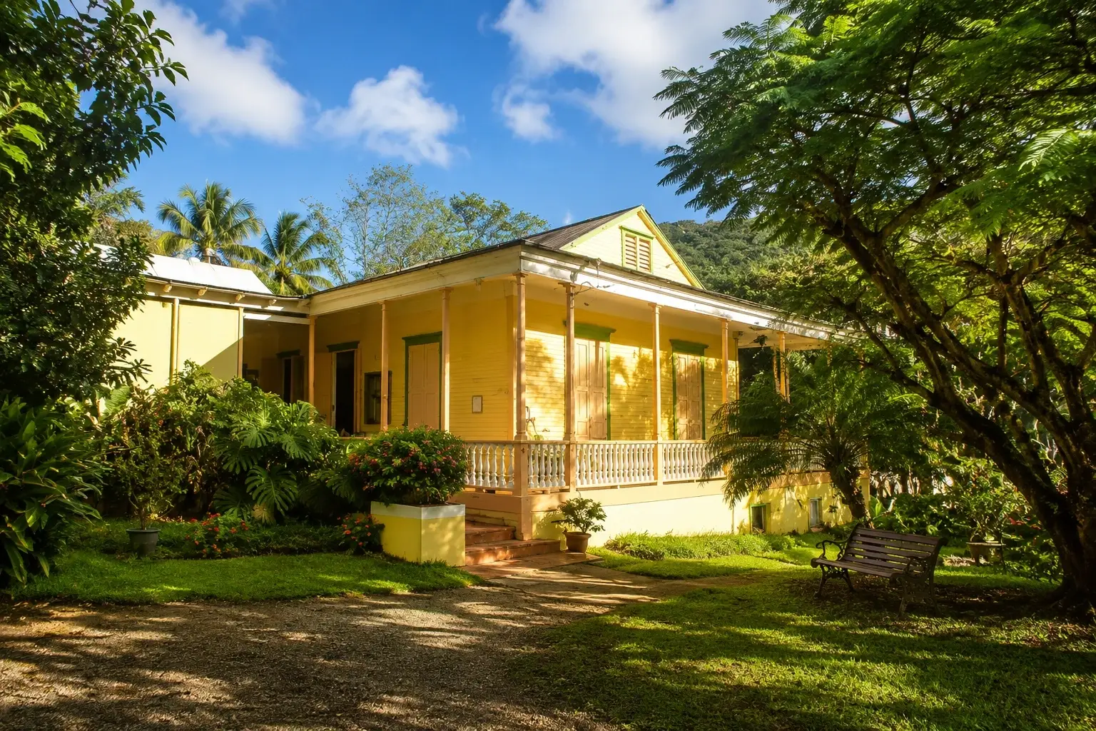Traditional yellow hacienda surrounded by lush tropical gardens and mountain vegetation in Adjuntas, Puerto Rico.