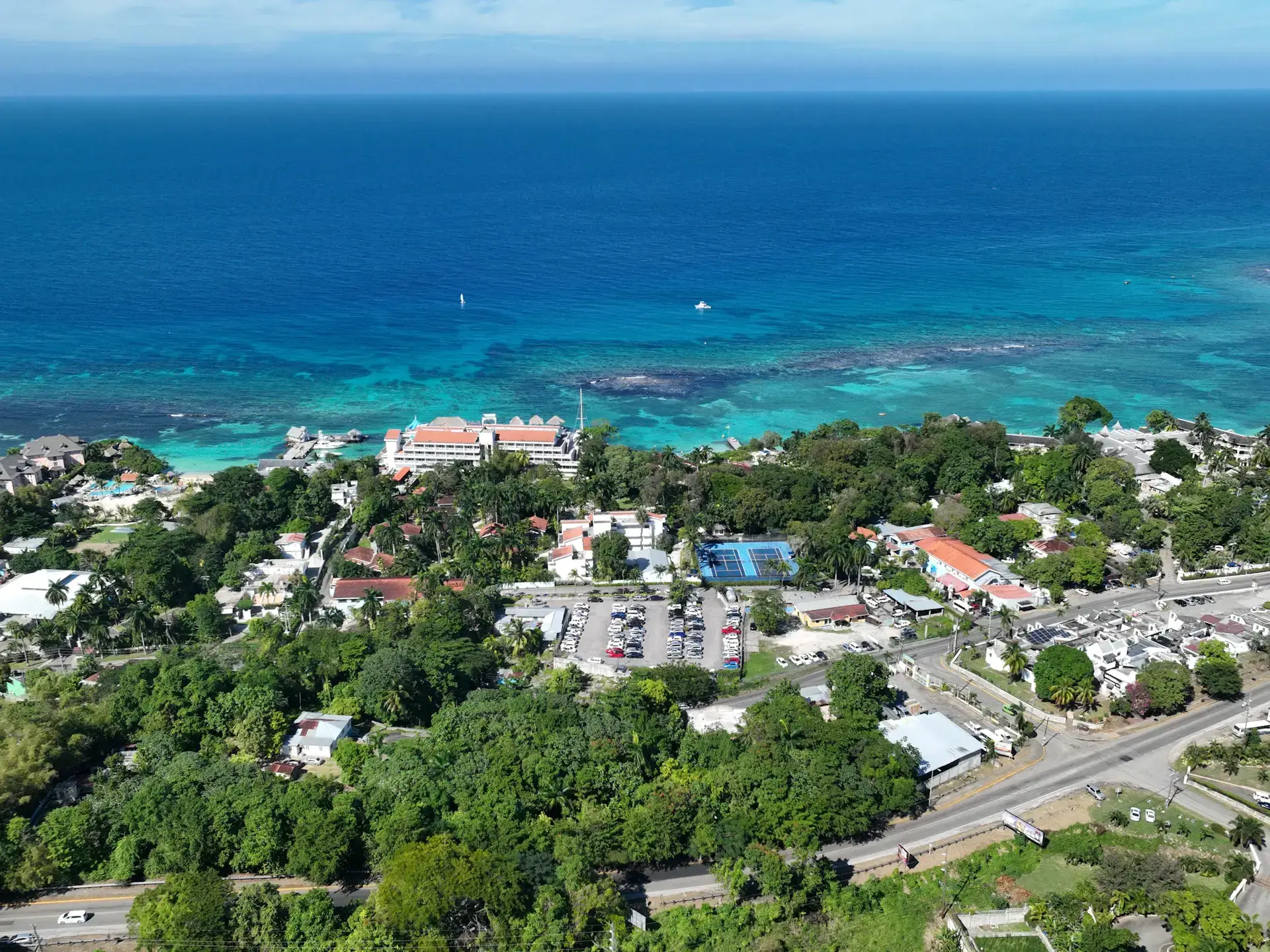 Aerial view of coastal buildings and turquoise water in Jamaica