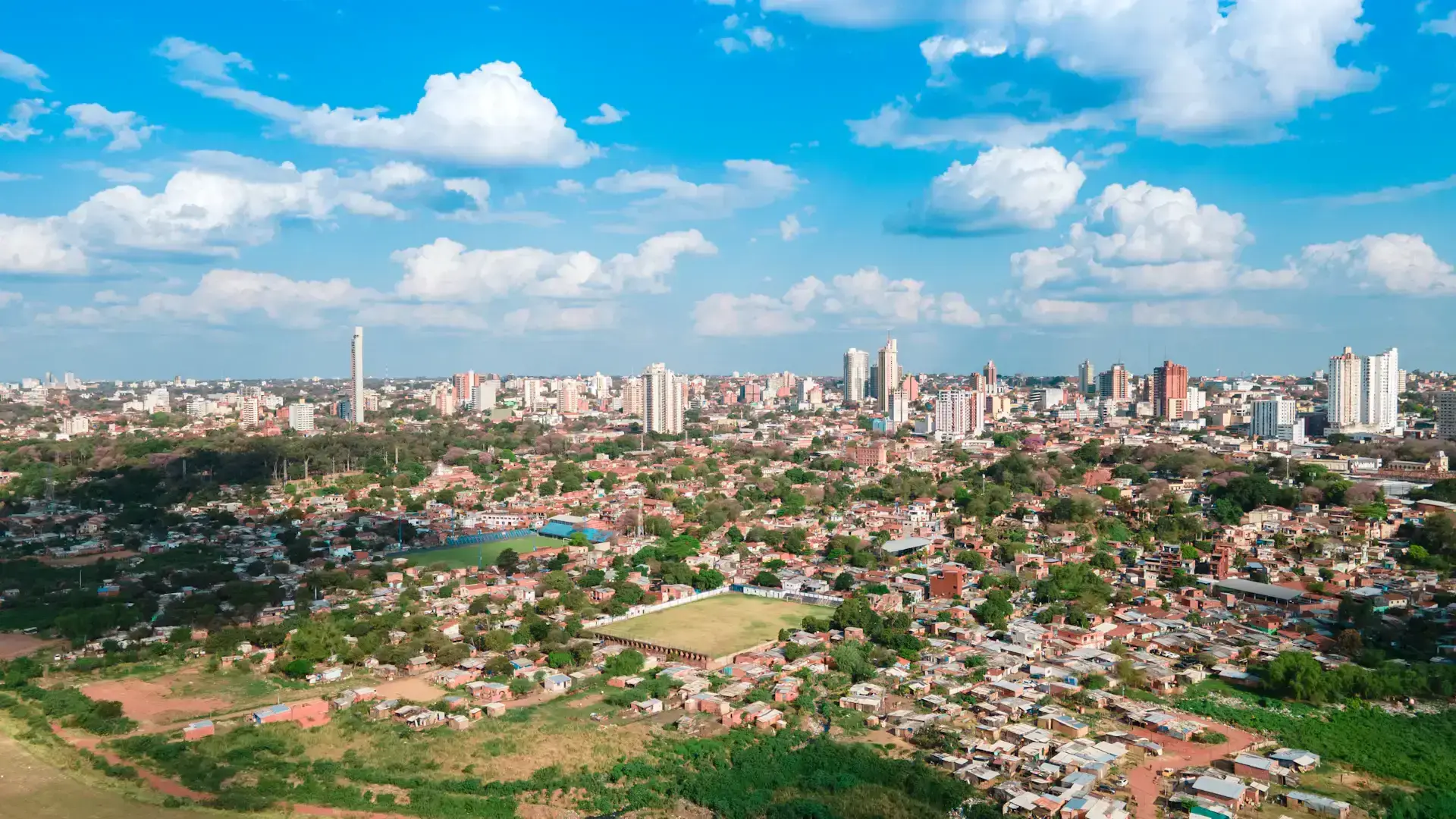 Asunción’s skyline, neighborhoods and green spaces beneath a bright blue sky in Paraguay