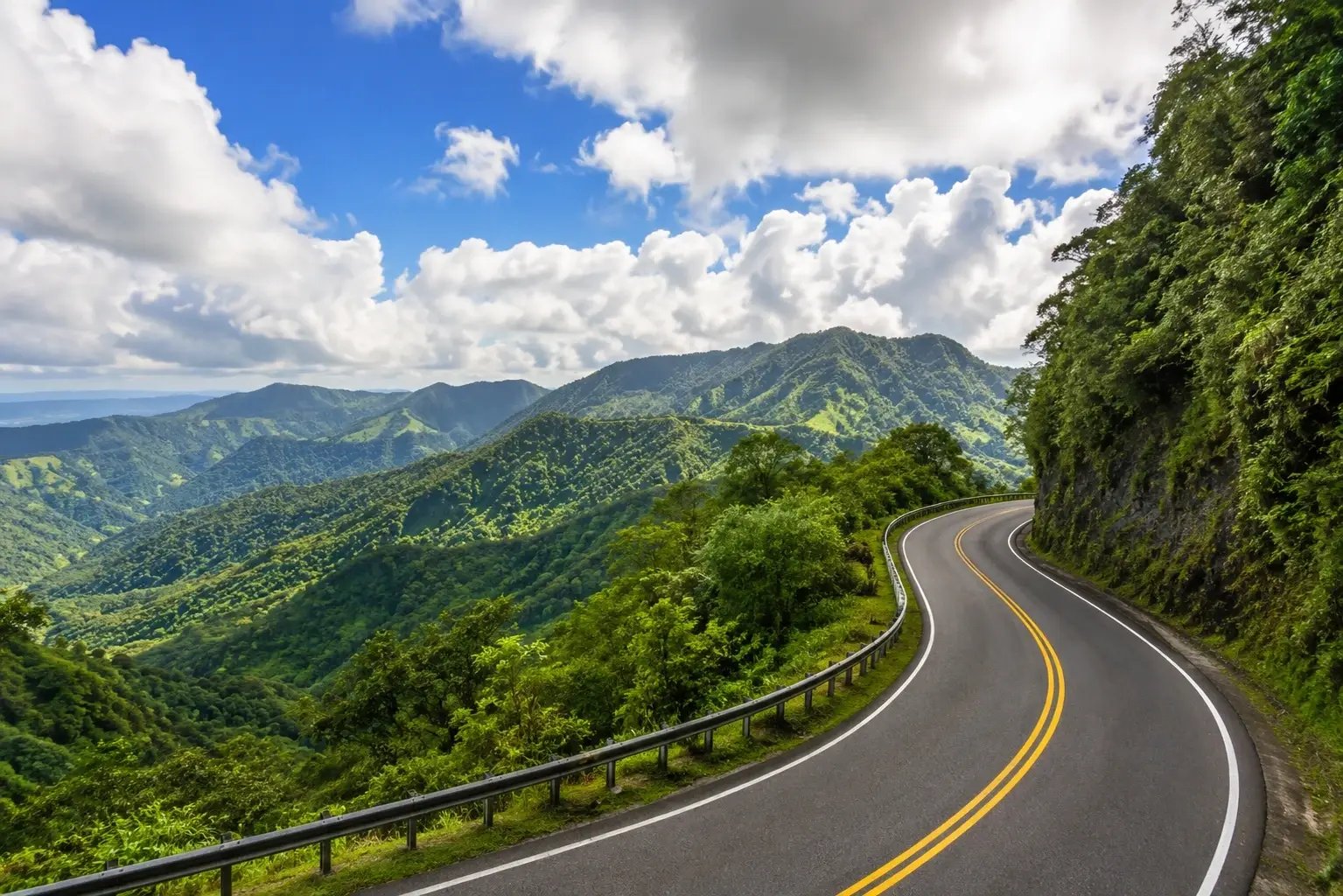 Winding scenic road through lush green mountains along the Ruta Panorámica in Adjuntas, Puerto Rico.
