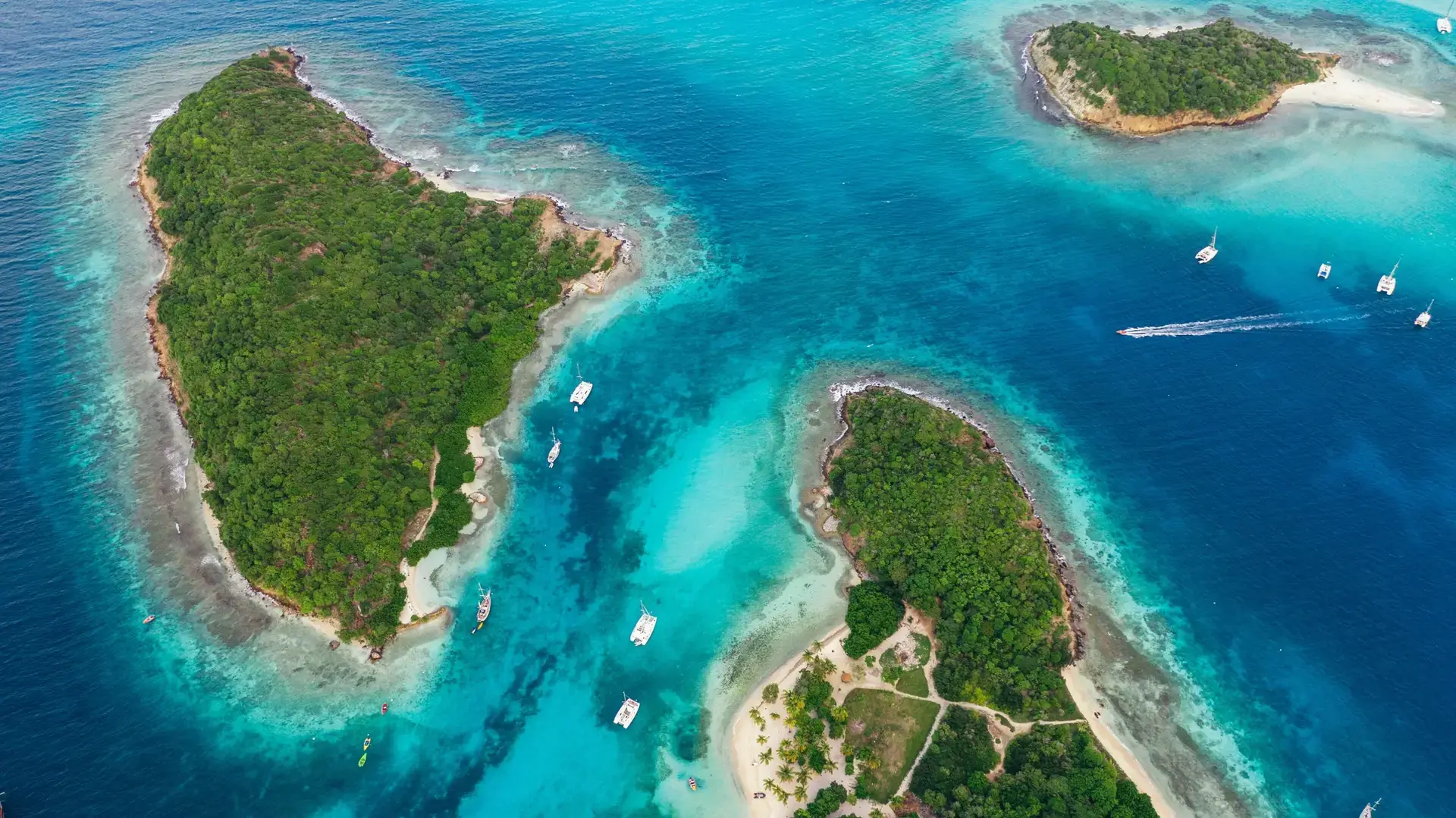 Aerial view of turquoise water and islands at Tobago Cays, with Petit Rameau and Baradal